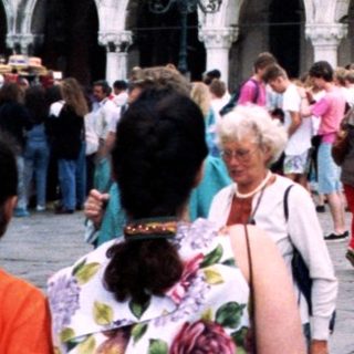 Venetian Doge's Palace with crowd in Piazza San Marco.
