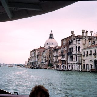 Venetian canal with historic buildings and water.