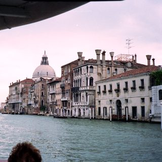 Venetian canal with historic buildings and water.