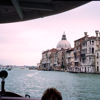 Venetian canal with historic buildings and water.