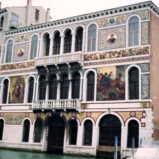 Venetian canal building with elaborate frescoes.