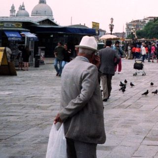 Busy Piazza San Marco, Venice, with tourists and pigeons.