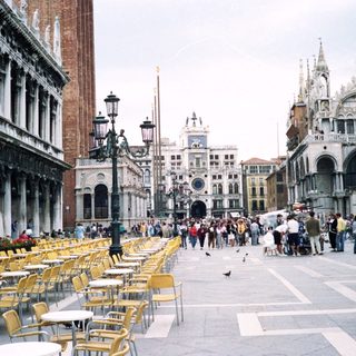 Venetian Piazza with historic architecture and outdoor seating.