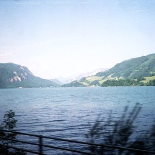 Scenic lake surrounded by green mountains.