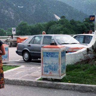 Family posing at EuroService currency exchange in mountainous area.