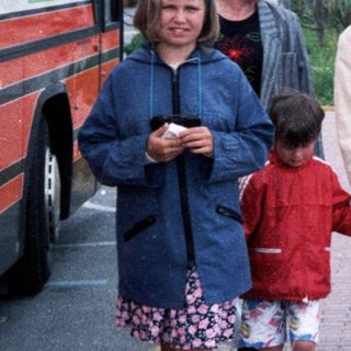 Family walking near coach with "Resident NV" label.