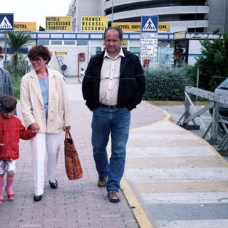 Family walking near coach with "Resident NV" label.