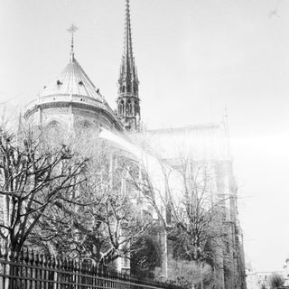 Historic cathedral with Gothic spires in foggy setting.