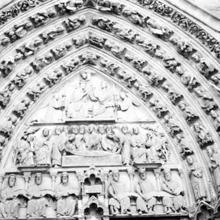 Gothic cathedral façade with intricate sculpted religious reliefs.