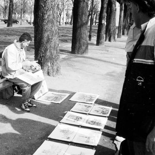 Man sitting on bench eating outdoors.