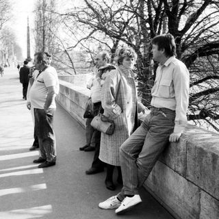 People waiting in line outdoors during daytime.