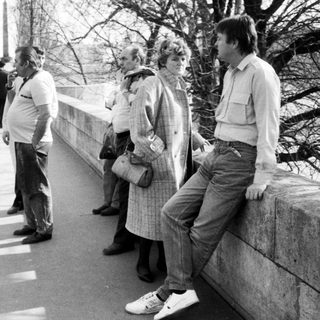 People waiting in line outdoors during daytime.