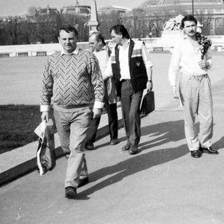 People walking on a bridge in city during daytime.