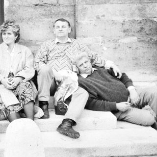 Four people posing together on stone steps.