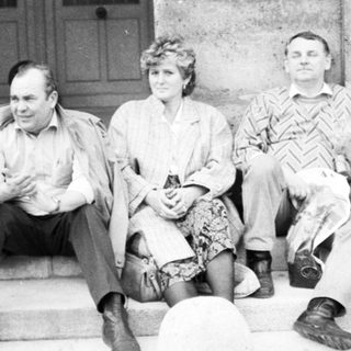 Four people posing together on stone steps.