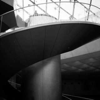 Modern architectural atrium with curved ceiling.
