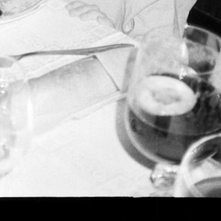 A woman and child eating together indoors.