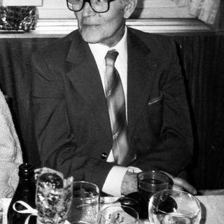 Two elderly people dining together indoors.