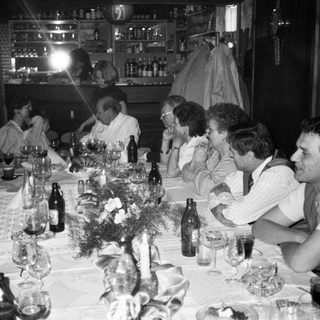 Group gathered around a long table for a social meal.