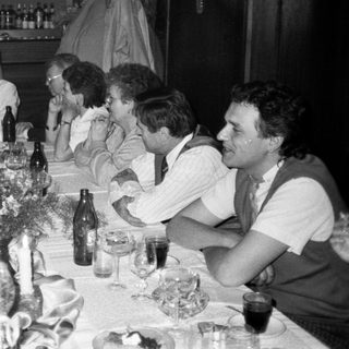 Group gathered around a long table for a social meal.