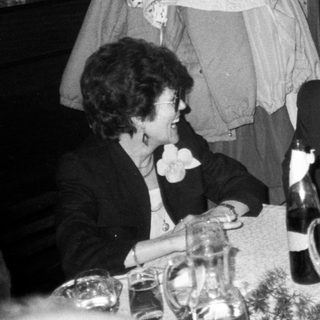 Formal dinner party with guests laughing. Wedding-related event.