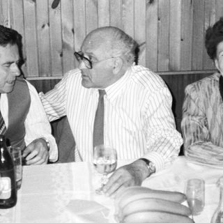 Three people enjoying a meal together indoors.
