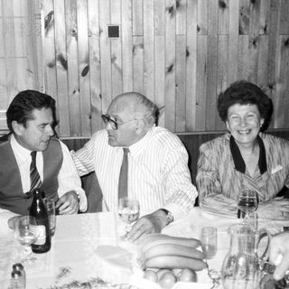 Three people enjoying a meal together indoors.