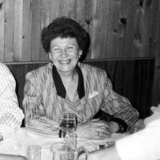 Three people enjoying a meal together indoors.