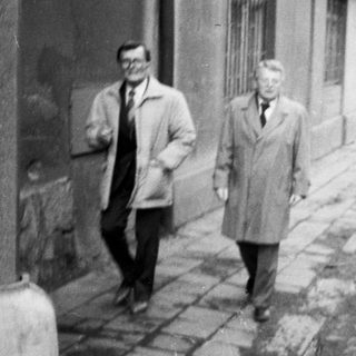 Four people walking together on a city street.