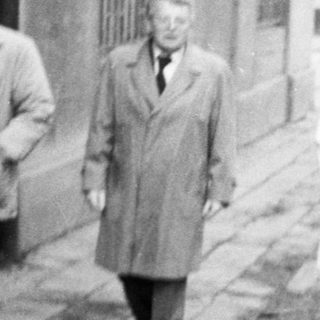 Four people walking together on a city street.