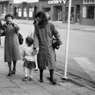 People walking together on a street in a small town.