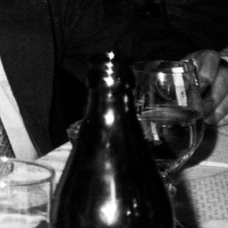 Two people engaged in conversation indoors.
