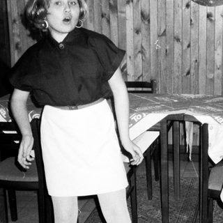 Two children playing with a balloon indoors.