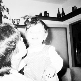 Tender moment between adult and child indoors.