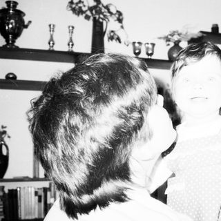 Tender moment between adult and child indoors.