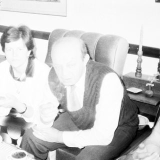 Three people enjoying a meal together indoors.