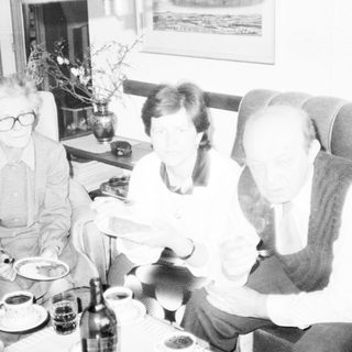 Three people enjoying a meal together indoors.