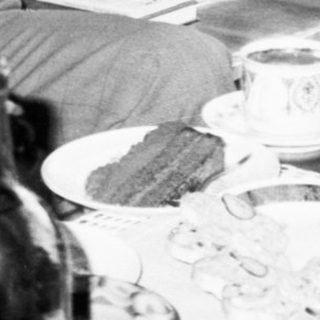 Family sharing meal indoors during casual gathering.