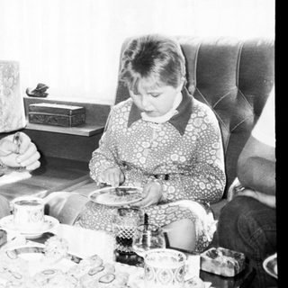 Family sharing meal indoors during casual gathering.