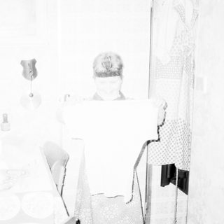 Minimalist room display with vintage items and blurred figure.