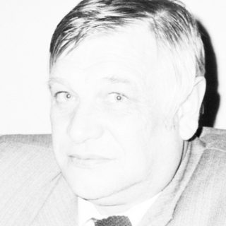 Man in formal attire during indoor event.