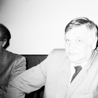 Man in formal attire during indoor event.