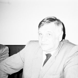 Man in formal attire during indoor event.