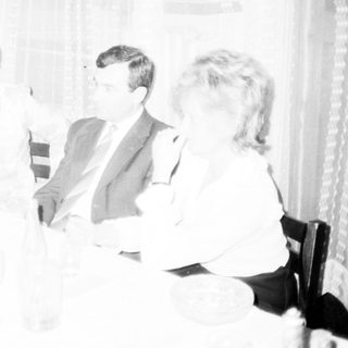 Formal gathering of people seated indoors discussing.
