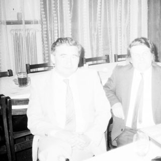 Business meeting or conference with men seated.