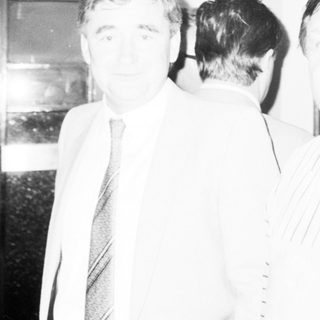 Two men in formal attire at indoor event.