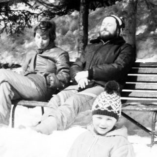 Family enjoying snow play outdoors.