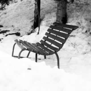Three people playing in deep snow.