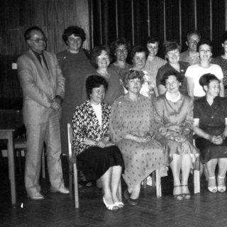 Group of people posing indoors at an event.