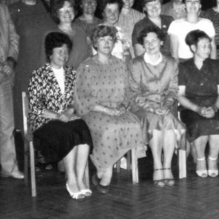 Group of people posing indoors at an event.